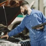 A mechanic examining a car engine
