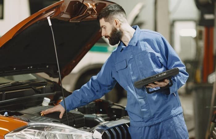 A mechanic examining a car engine