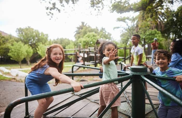Children playing happily on a merry-go-round